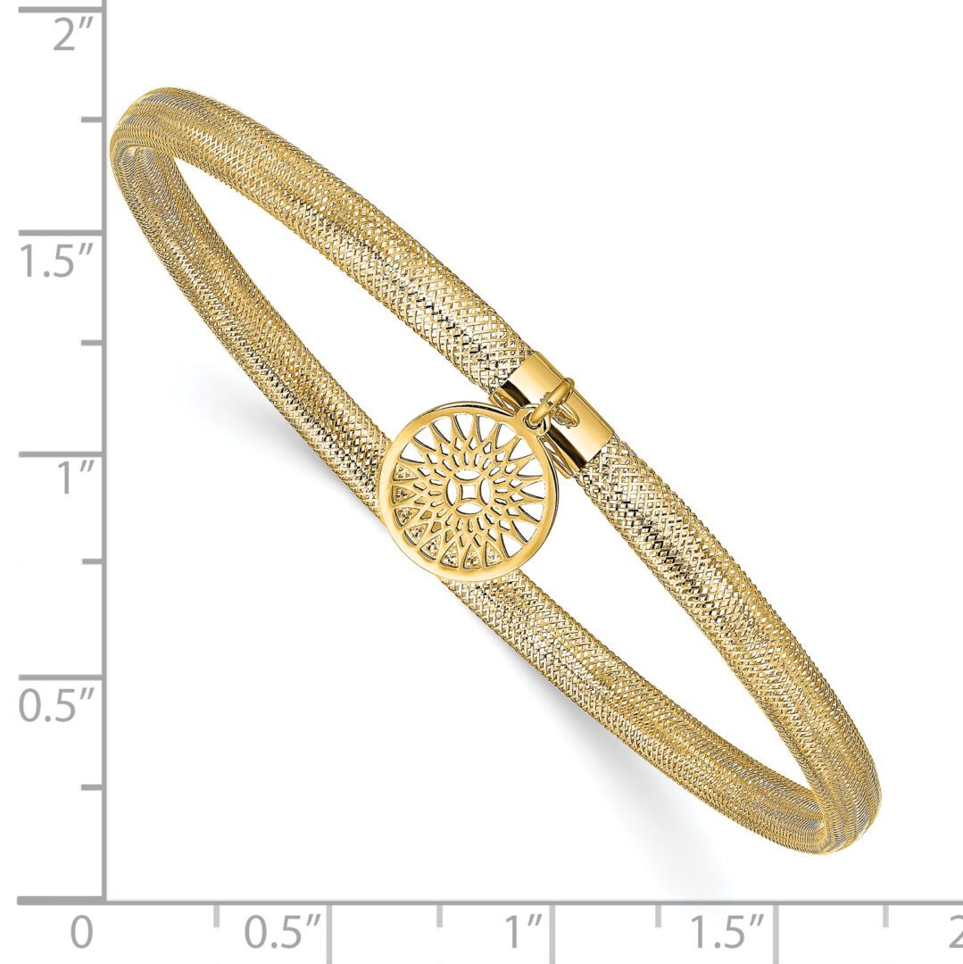 Gold bracelet with circular decorative clasp.