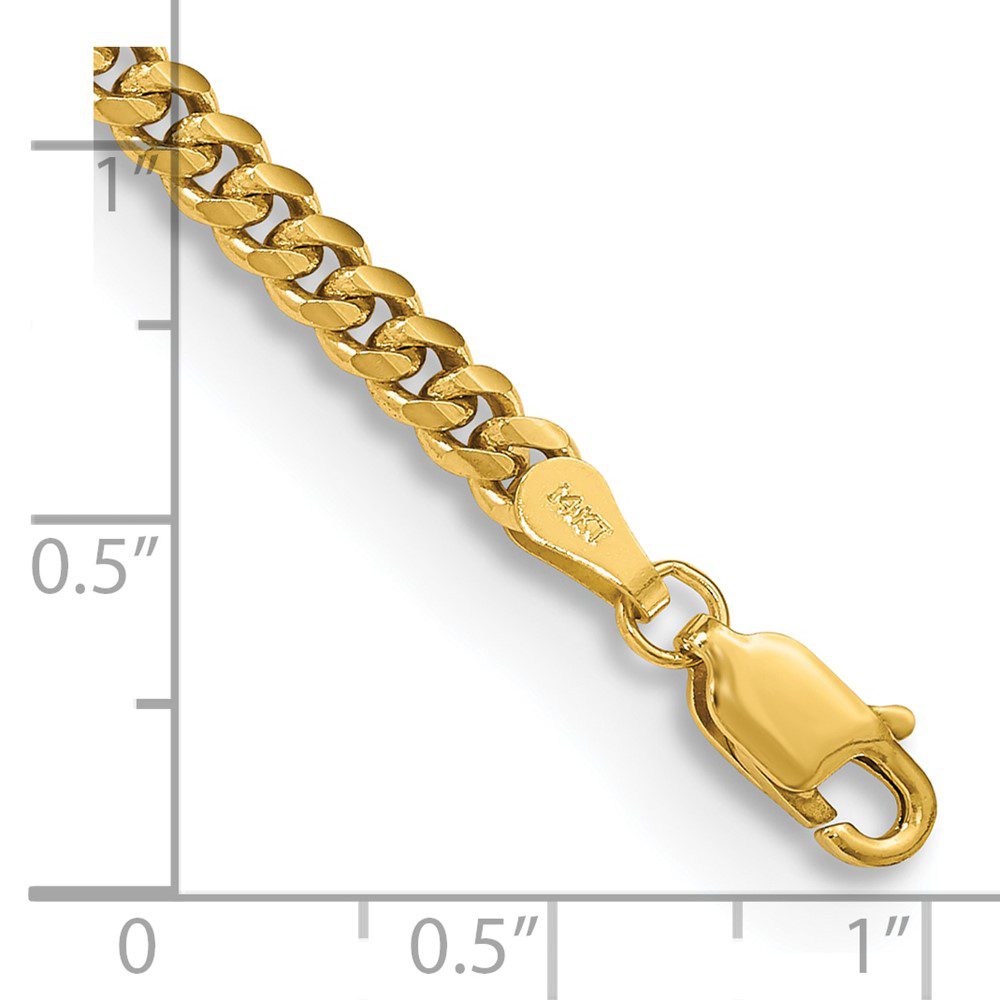 Close-up of a gold chain bracelet with a lobster clasp and measurement scale.