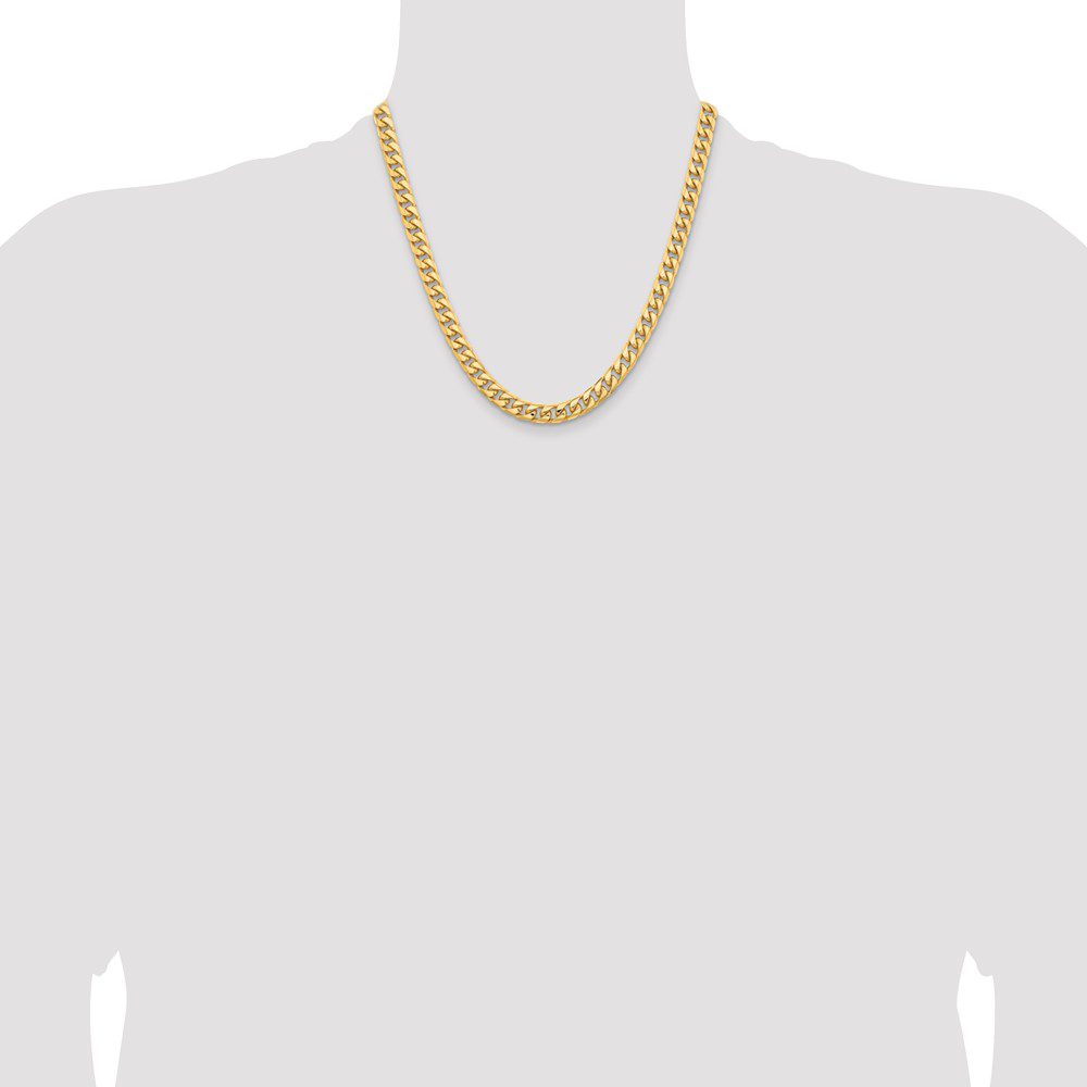 Gold chain necklace on a plain background.