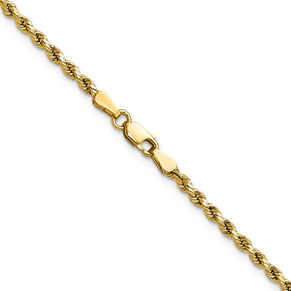 Close-up of a gold chain bracelet with a heart-shaped link.