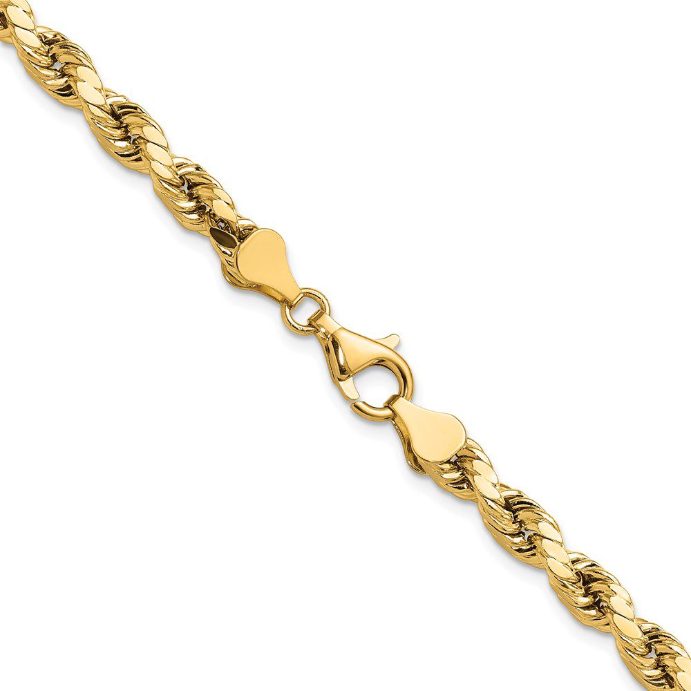 Close-up of a gold heart-shaped link chain bracelet.