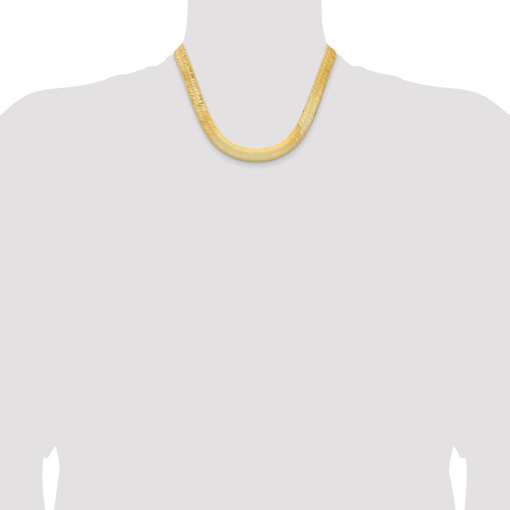 Simple gold chain necklace on a mannequin bust.