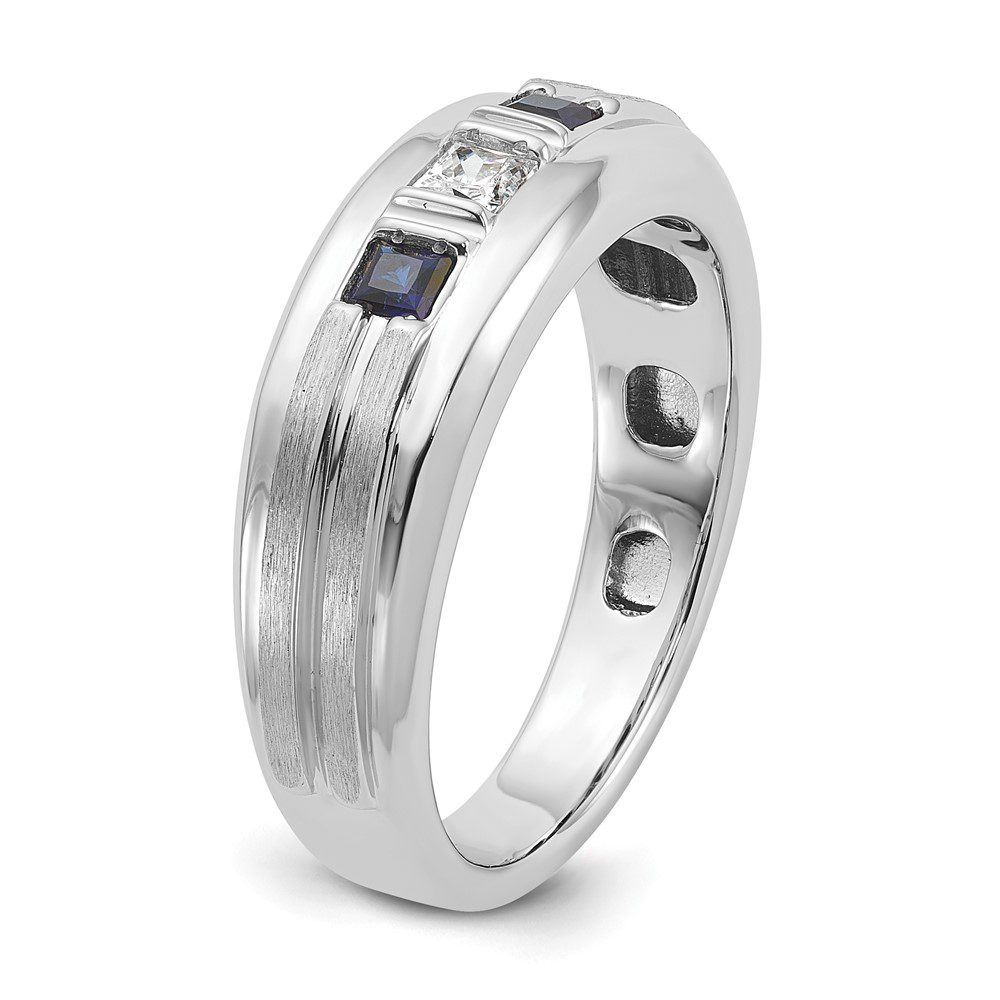 Silver ring with a rectangular blue gemstone and textured band.