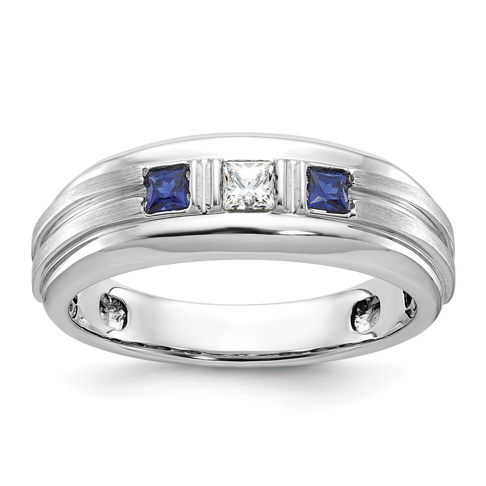 Elegant silver ring with two blue stones and a central diamond.