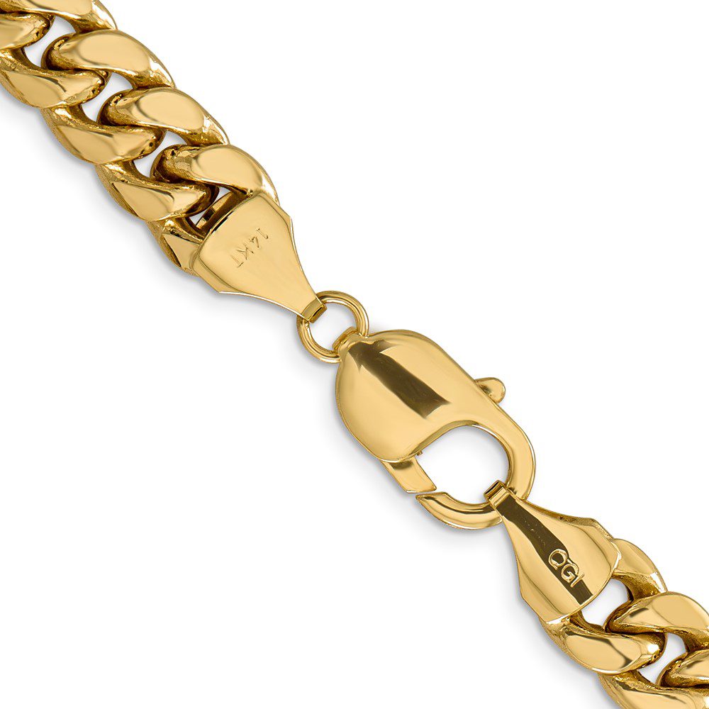 Close-up of a gold chain necklace with a lobster clasp.