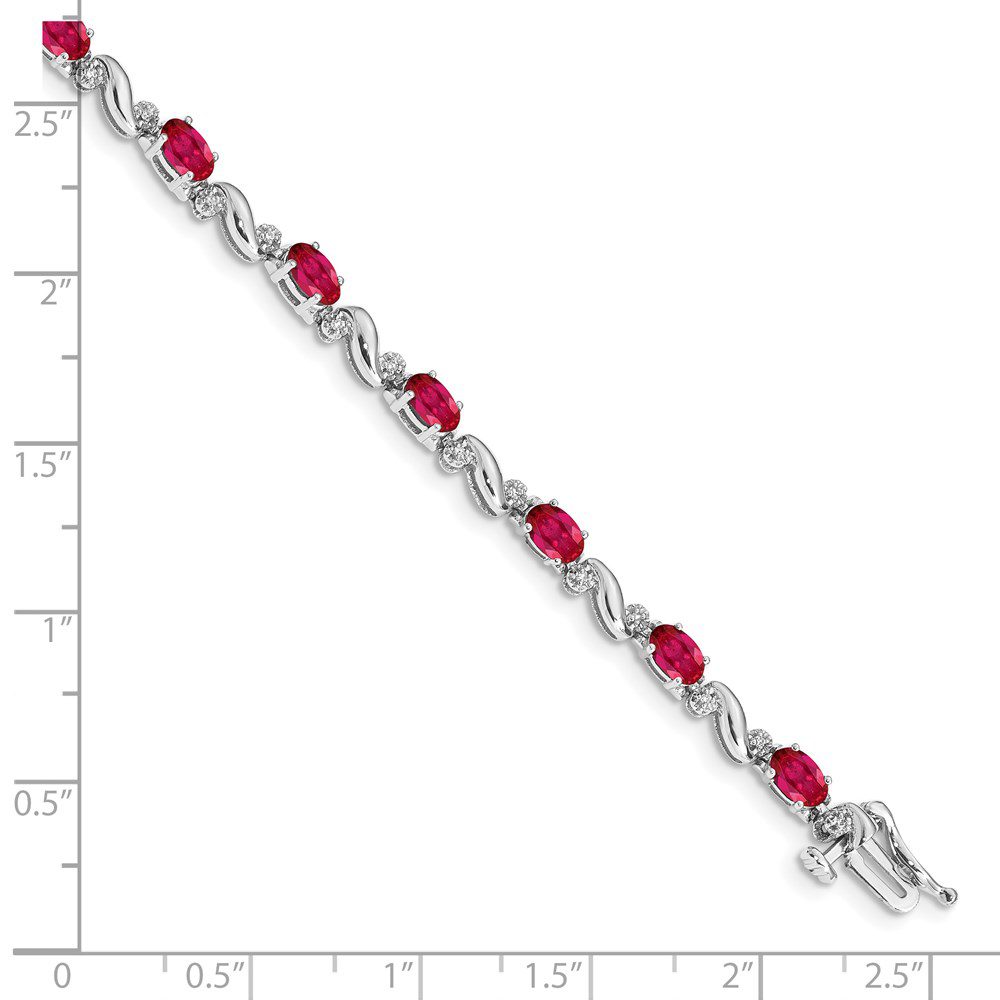 Elegant silver bracelet with alternating red and clear gemstones.