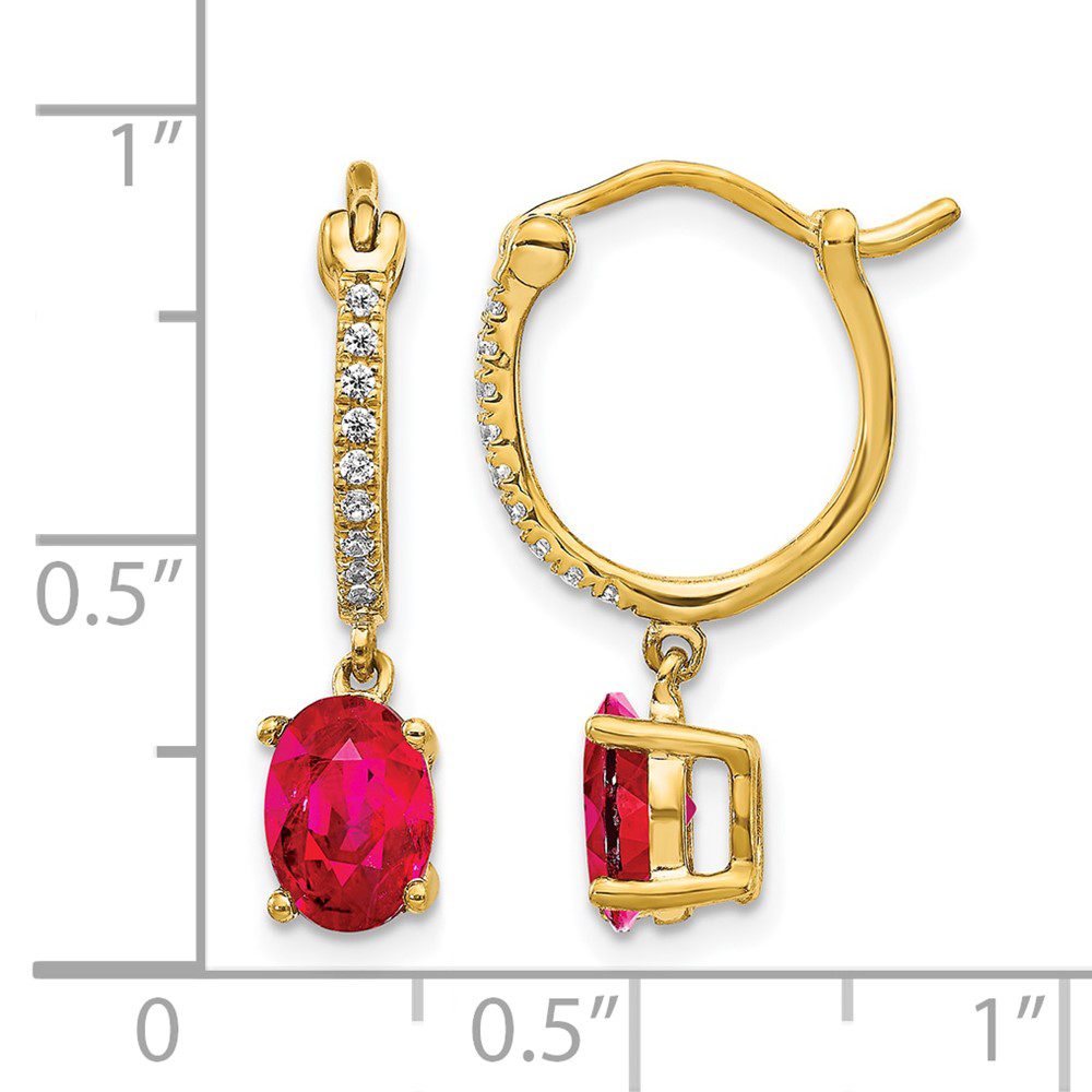 Gold earrings with red gemstones and small diamonds.