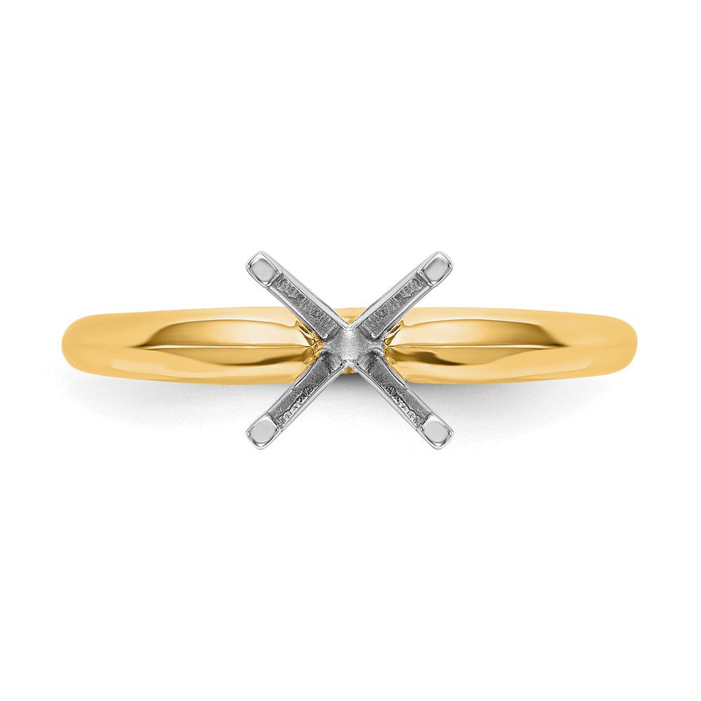 A gold ring setting ready for a gemstone to be mounted.