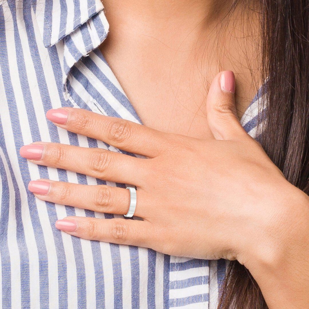 Woman showing off an engagement ring on her hand.