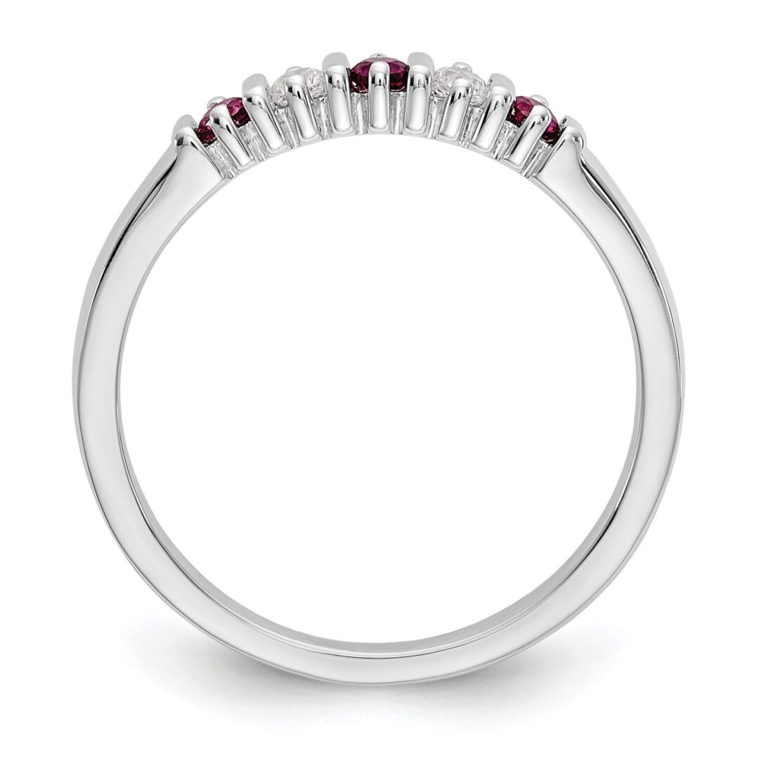 Elegant silver ring with small red gemstones.