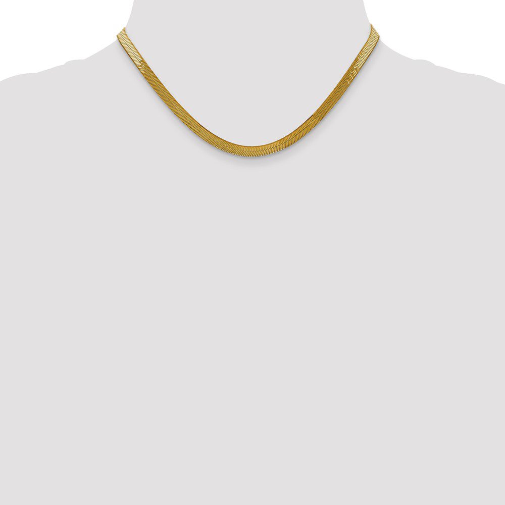 Simple gold chain necklace displayed on a white bust.