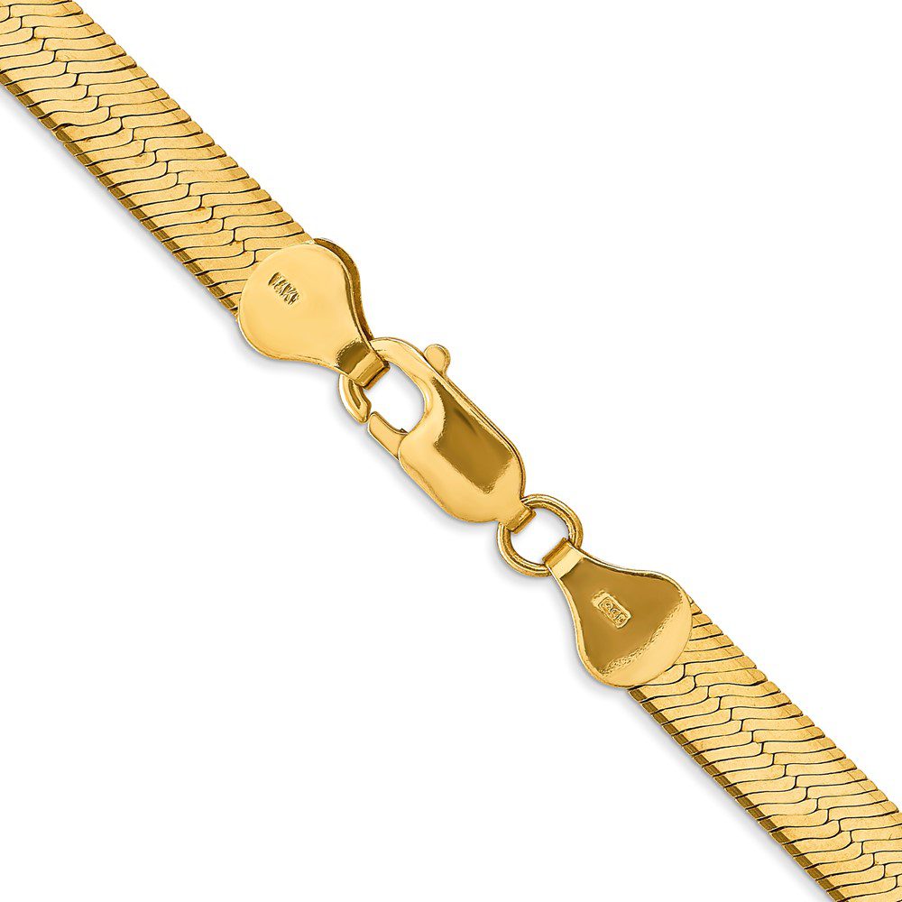 Gold necklace with a heart-shaped clasp.