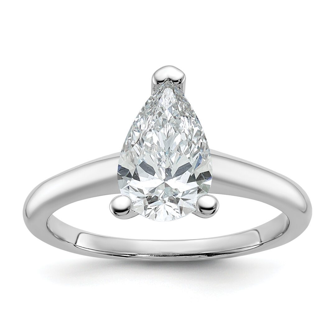 Elegant pear-shaped diamond ring with a simple silver band.