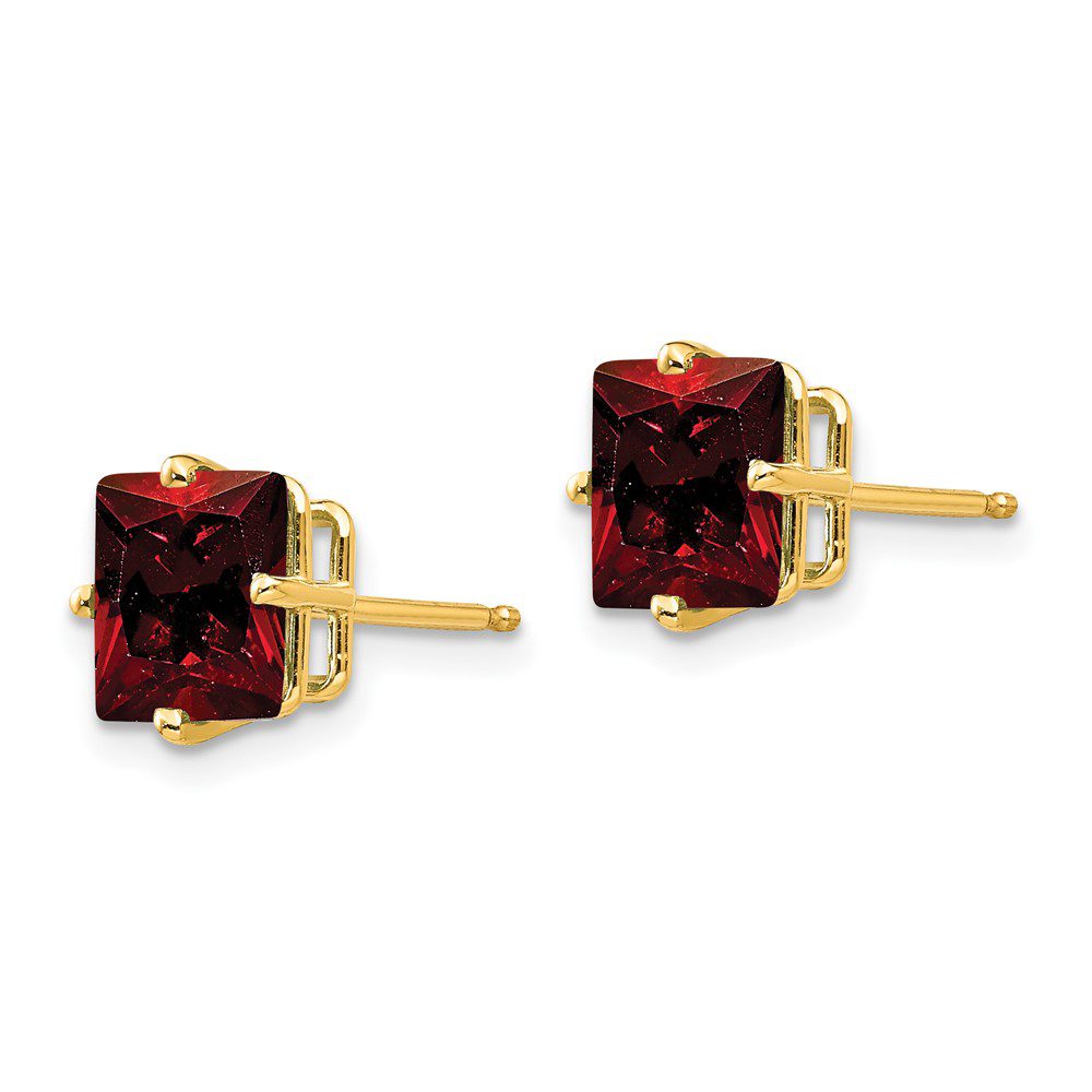 A pair of elegant red gemstone stud earrings with gold settings.