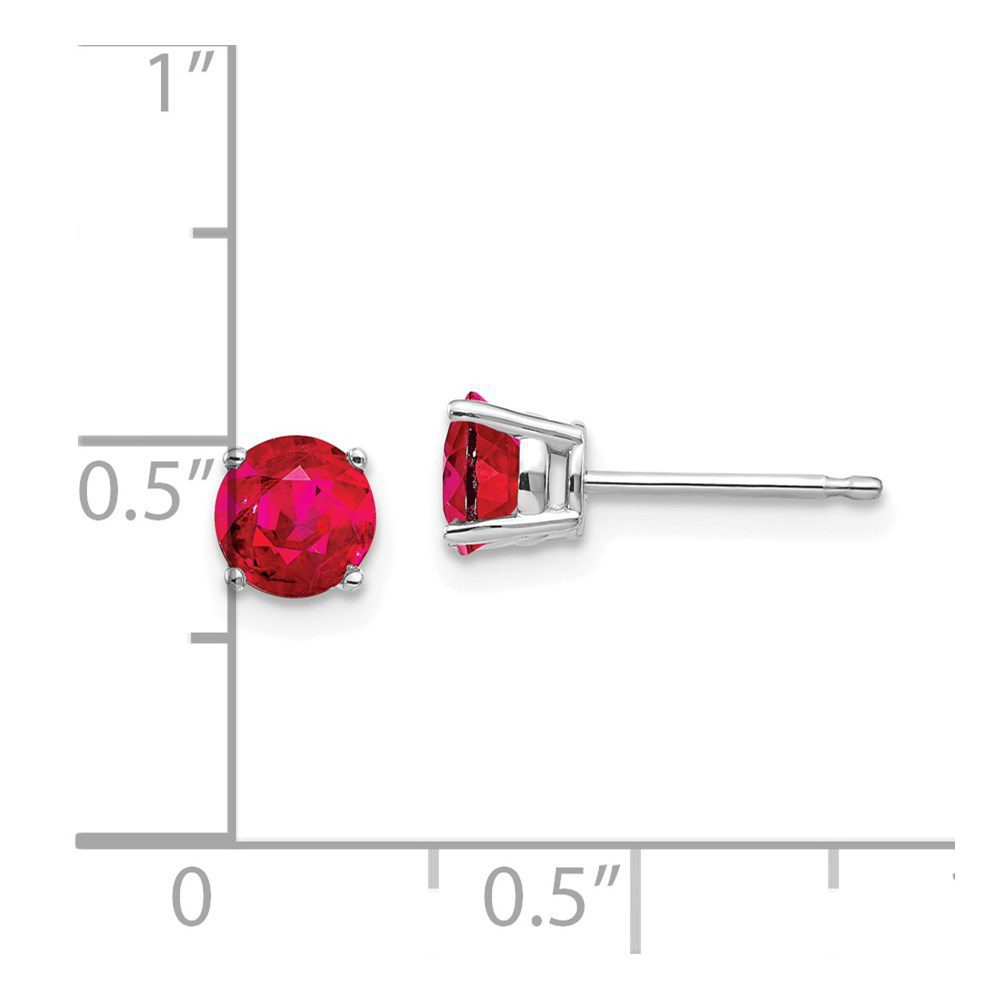 Pair of red gemstone stud earrings with silver settings.
